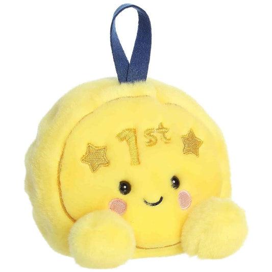 Front view of the Aurora Palm Pals Champs Gold Medal stuffed toy showing a bright yellow body, "1st" embroidery, and a blue ribbon loop.