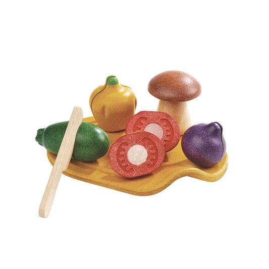 The PlanToys wooden assorted vegetables set featuring a cutting board, wooden knife, and sliceable toy food.