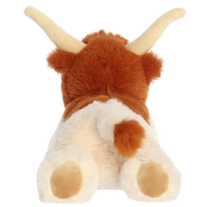 Back view of the Aurora Flopsie longhorn plush toy showing its white back with brown patches, tan hind hooves, and a brown-tipped tail.