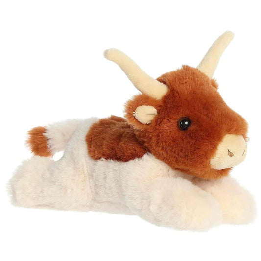 Angled view of the Aurora Flopsie 8-inch Buck Longhorn Cow plush laying down, showing its brown and white patched fur and impressive tan horns.