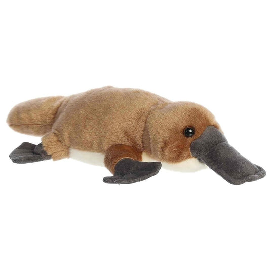 Angled side view of the Aurora Flopsie 8-inch Bindi Platypus plush laying down, showing its soft brown fur, dark grey bill, and dark webbed feet.