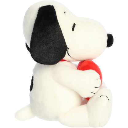 Side profile thumbnail of the Snoopy plush showing his rounded snout, side profile, and the red heart tucked into his paws.