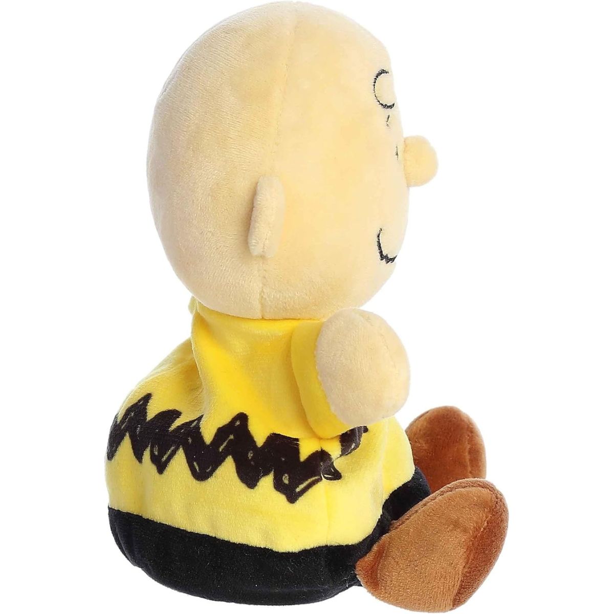 Side profile thumbnail of the mini Charlie Brown plush highlighting his round head shape, profile of his yellow shirt, and soft seated posture.