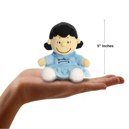 The miniature Peanuts Lucy plush sitting balanced in an open human hand under a 5-inch height graphic indicator.