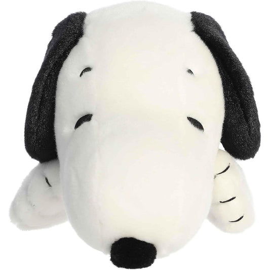 Straight-on front view of the soft Snoopy plush lying down, showing his large black nose and floppy ears.