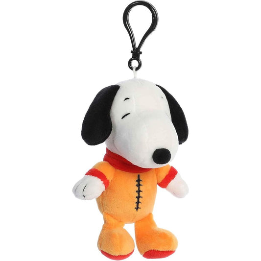 Front view of the Aurora Peanuts Astronaut Snoopy 5-inch clip-on plush featuring an orange spacesuit and a black plastic keychain clip.