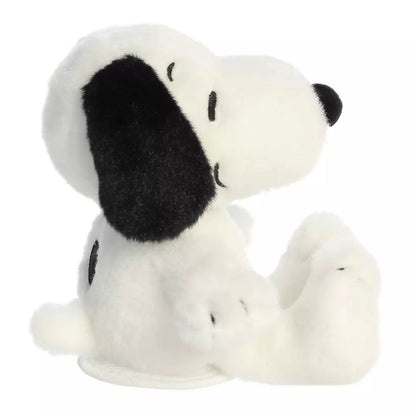 Side profile view of the cuddly Snoopy plush sitting comfortably.