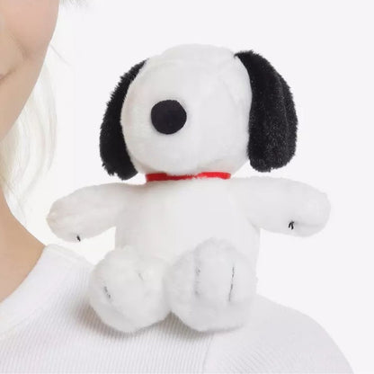 The 5-inch Aurora Peanuts Shoulderkins Snoopy plush sitting securely on a person's shoulder, highlighting his red collar.
