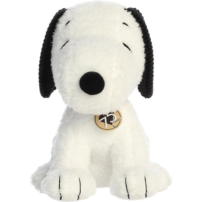 Straight-on front view of the soft Snoopy plush sitting upright, showing his textured black ears and 75th-anniversary tag.