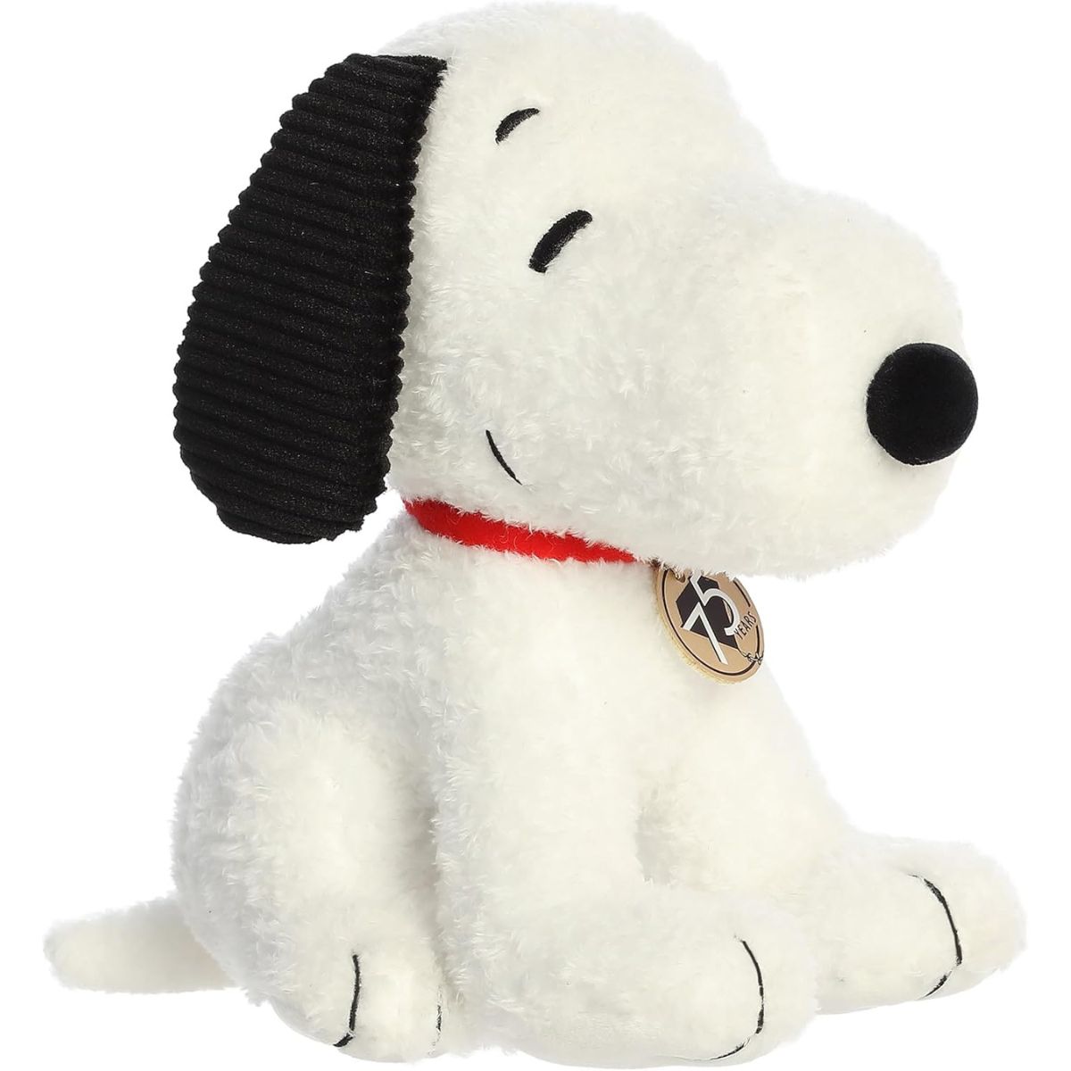 Angled front view of the 10-inch Aurora Peanuts 75th Anniversary Limited Edition Snoopy stuffed animal sitting down with his gold medallion.