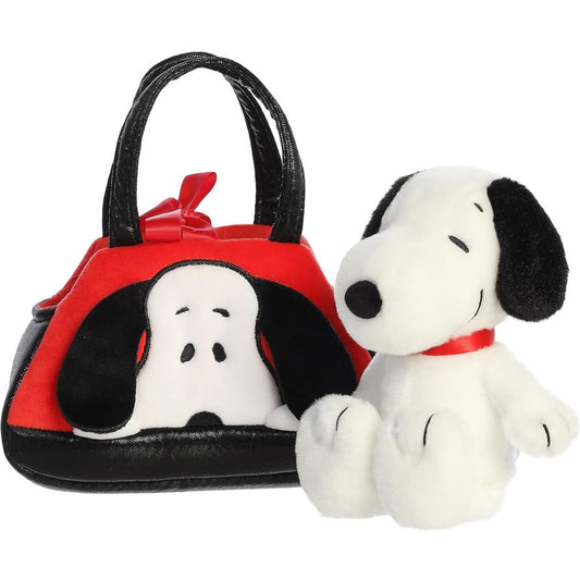 Front view of the Aurora Fancy Pals Peanuts Snoopy plush sitting next to its red and black purse carrier.