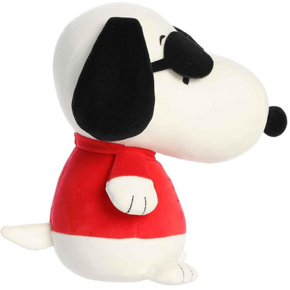 Side profile of the Aurora Peanuts Squishy Joe Cool Snoopy plush highlighting his red shirt and floppy black ear.