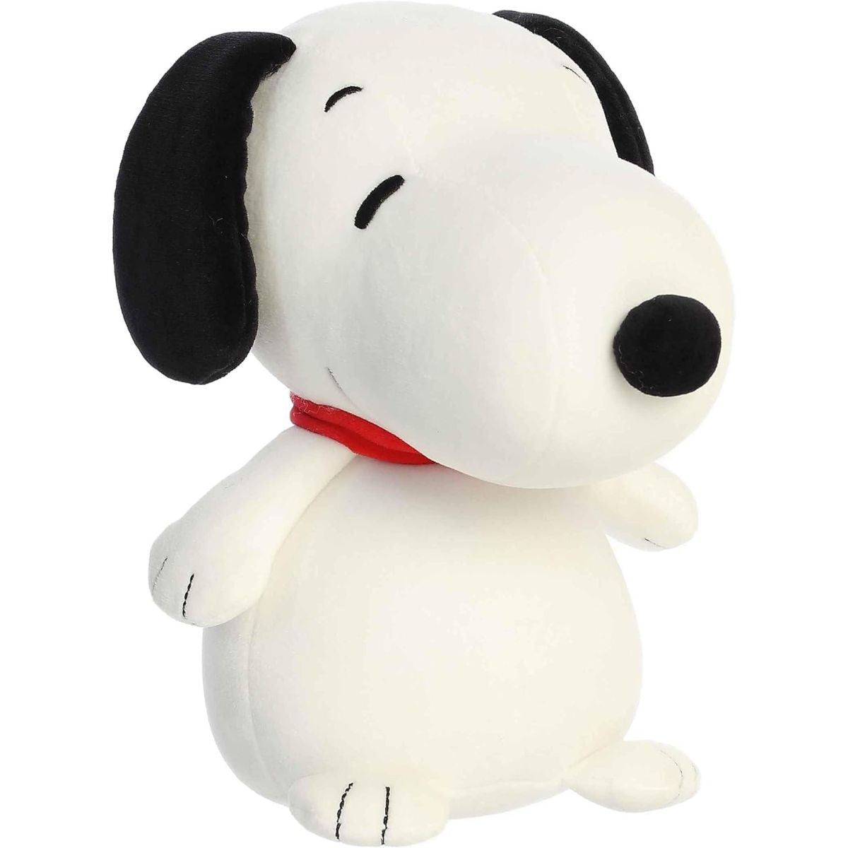Angled front view of the 8.5-inch Aurora Peanuts Squishy Snoopy plush sitting upright with a red collar.