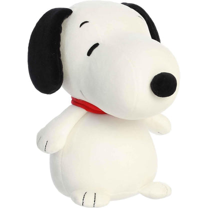 Angled front view of the 8.5-inch Aurora Peanuts Squishy Snoopy plush sitting upright with a red collar.