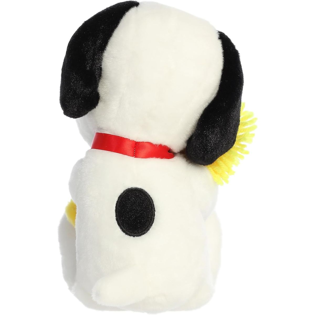 Direct back view of the Snoopy stuffed animal sitting down, highlighting his red collar, black back spot, and Woodstock's fluffy hair.