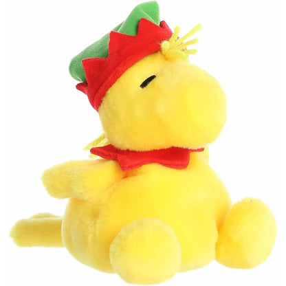 Aurora Palm Pals Elf Woodstock 5-inch plush stuffed toy sitting angled forward with a bright yellow body and a green elf hat.