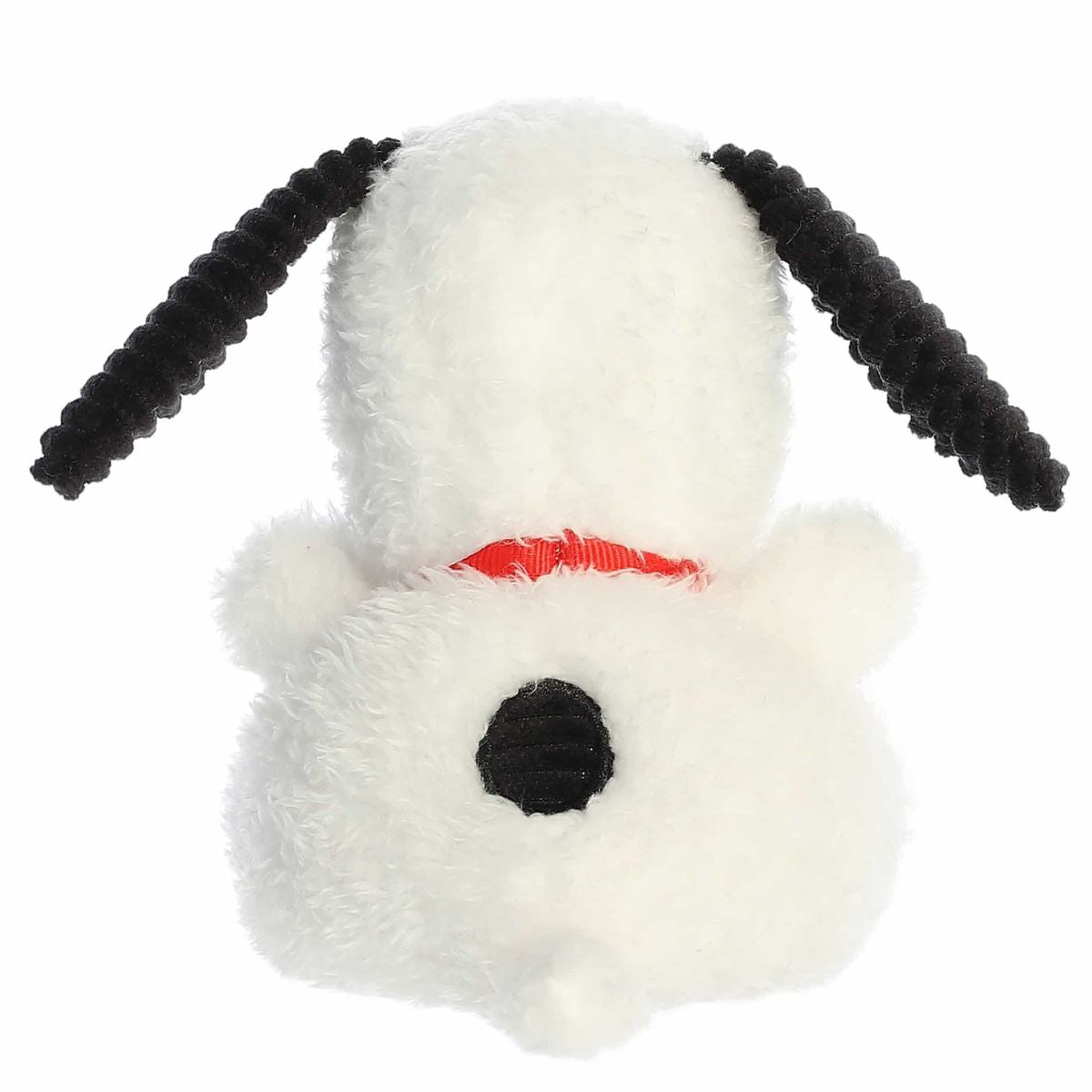 Back view of the Snoopy stuffed animal showing his fluffy white body, textured black ears, and signature black spot on his back.