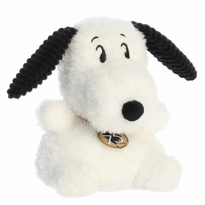 Front angled view of the Aurora Palm Pals Peanuts 75th Anniversary Snoopy plush featuring a red collar with a gold 75 tag.