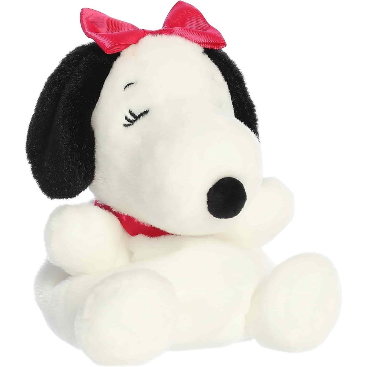 Front angled view of the 5-inch Aurora Palm Pals Peanuts Belle plush toy featuring white fur, black ears, a red collar, and a pink satin bow.