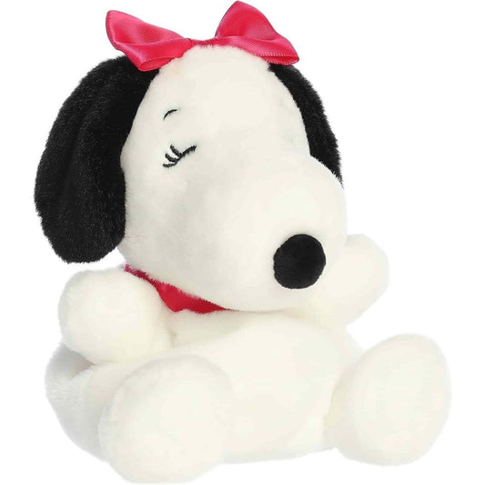 Front angled view of the 5-inch Aurora Palm Pals Peanuts Belle plush toy featuring white fur, black ears, a red collar, and a pink satin bow.