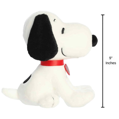 Side profile view thumbnail of the Snoopy plush sitting upright, showing his snout, short tail, red heart tag, and a 9-inch height measurement graphic indicator.
