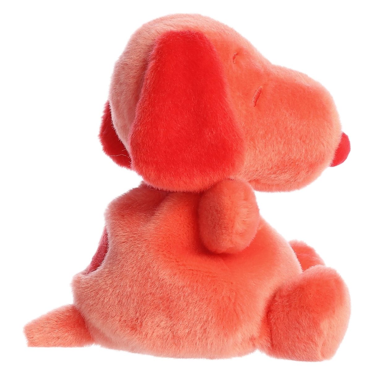 Side profile view of the Palm Pals Snoopy highlighting his plump shape, dark red floppy ear, and back spot.