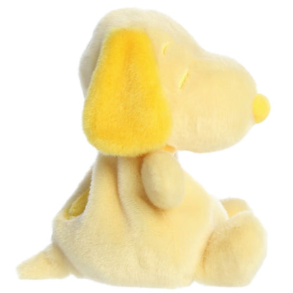 Side profile view of the Palm Pals Snoopy highlighting his plump shape, bright yellow floppy ear, and back spot.