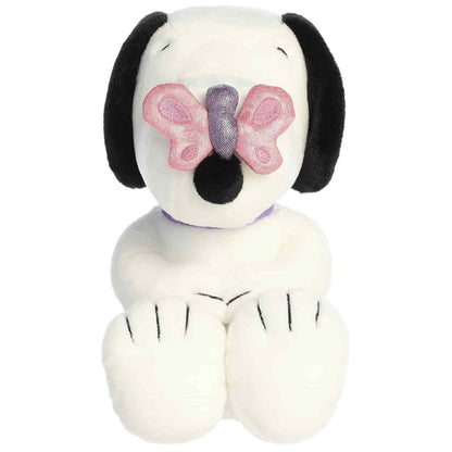 Straight-on front view of the soft Snoopy plush sitting upright with a pink butterfly covering his nose.