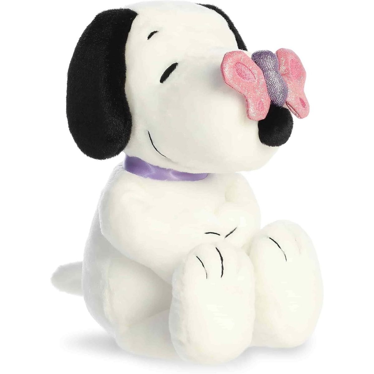 Angled front view of the 9-inch Aurora Peanuts Snoopy stuffed animal sitting down with a pink butterfly on his nose.