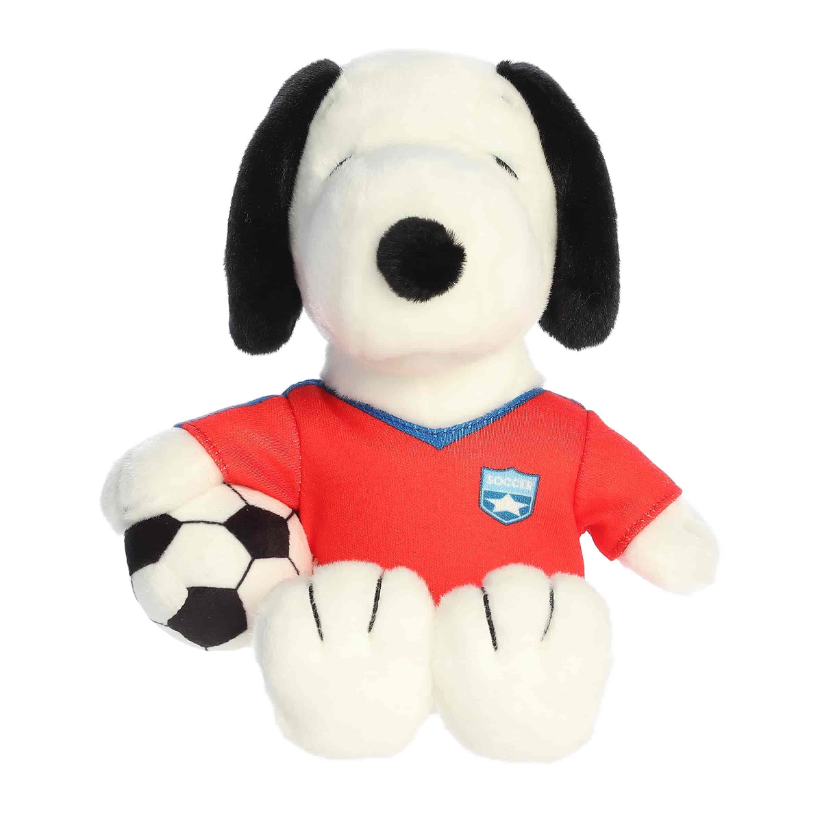 Straight front view of the sitting Snoopy stuffed animal showing his red jersey with a blue crest, black nose, and plush soccer ball.