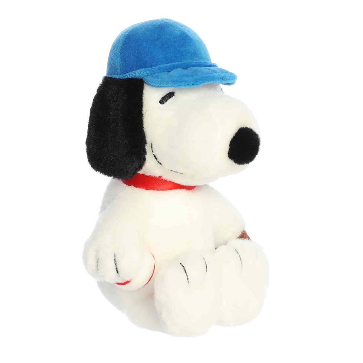 Angled front view of the Snoopy plush toy sitting and looking to the side, ready for the next pitch.