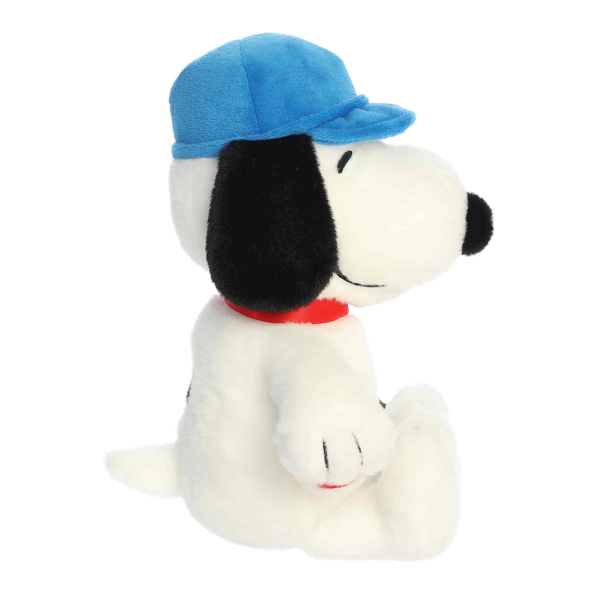 Side profile view of the Snoopy baseball plush highlighting his blue cap, floppy black ear, and short little tail.