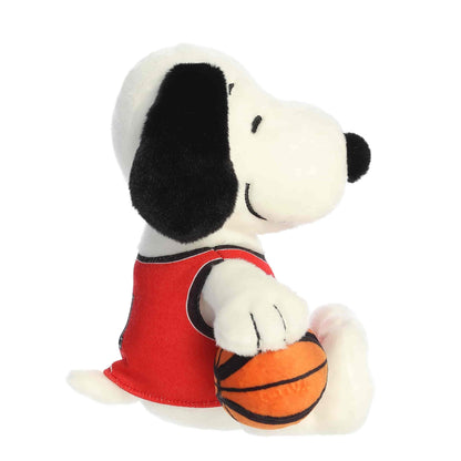 Side profile view of the Snoopy basketball plush highlighting his floppy black ear and the basketball tucked under his arm.