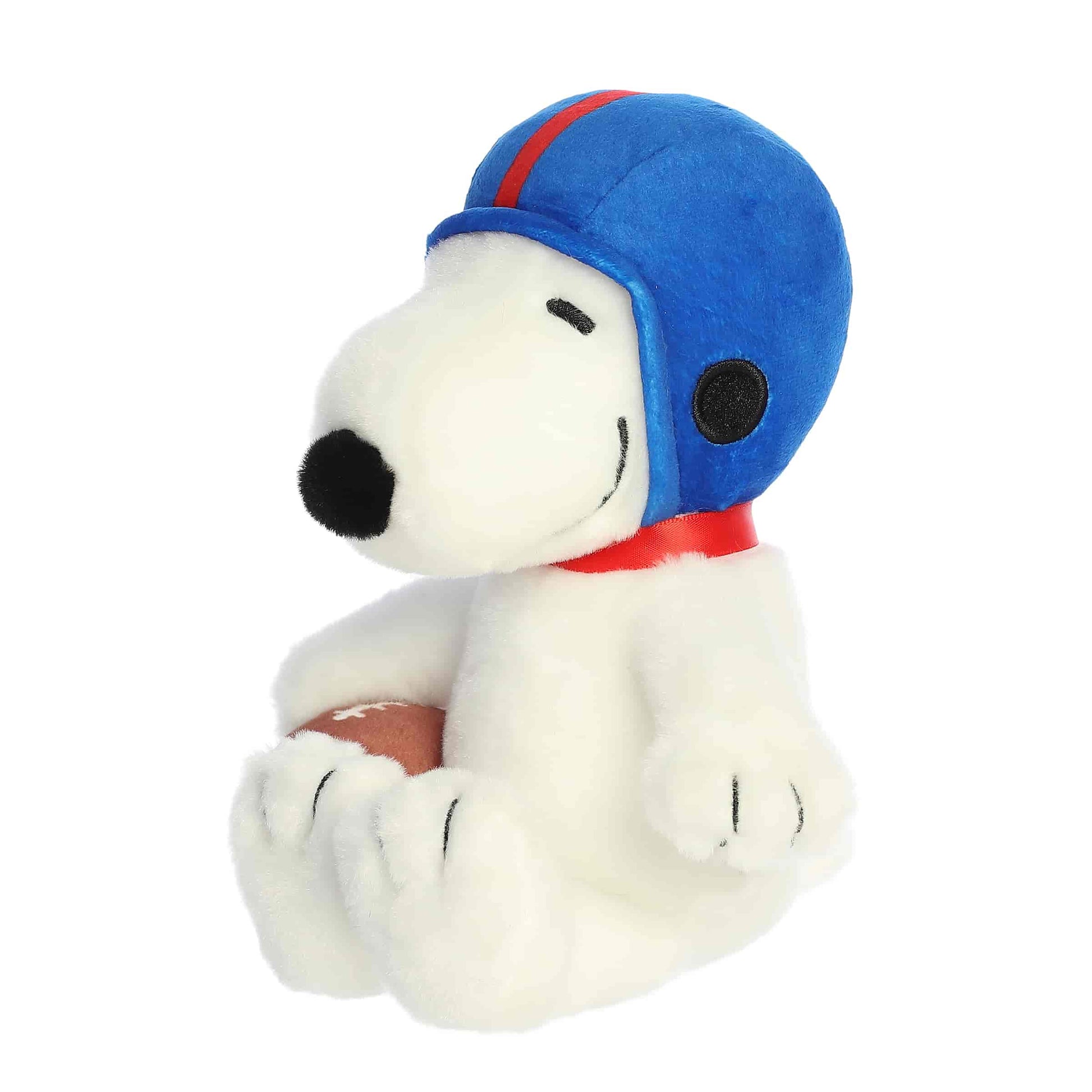 Angled front view of the Snoopy plush toy sitting and looking to the side, ready for the big game.