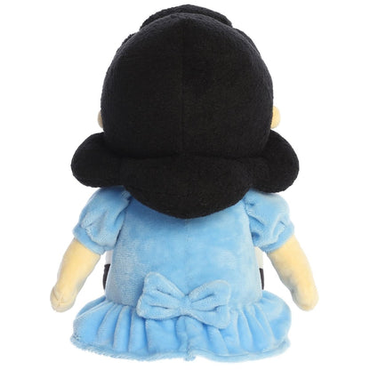 Direct back view of the cuddly Lucy stuffed animal sitting down, highlighting the blue bow on the back of her dress.