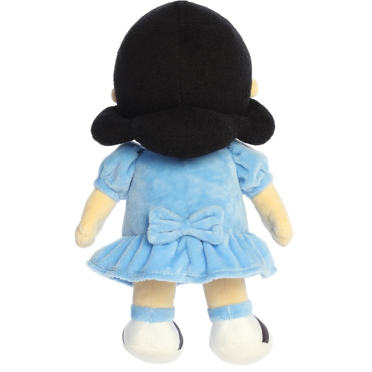 Back view of the Lucy stuffed animal standing up, showing her black hair and blue dress.
