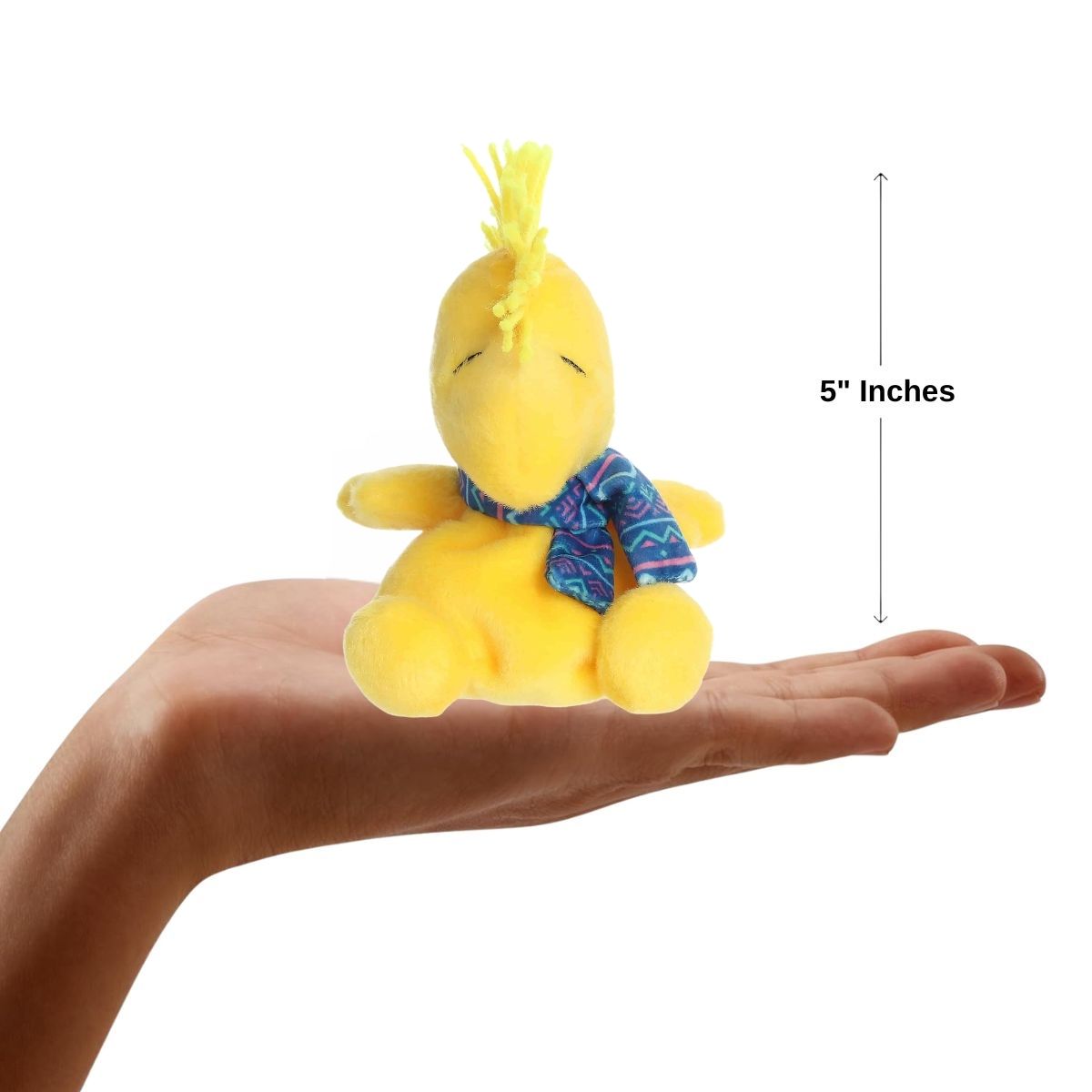A hand holding the Aurora Palm Pals Woodstock plush, demonstrating its small, 5-inch palm-sized design.
