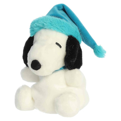 Aurora Palm Pals 5-inch Peanuts Bundled Up Snoopy plush toy with classic black-and-white fur and a bright teal winter hat.