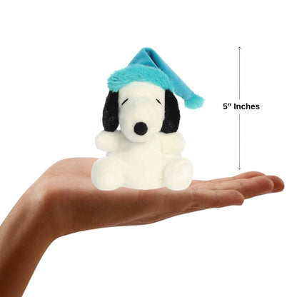 The miniature Bundled Up Snoopy plush sitting balanced in the palm of an open human hand under a 5-inch height graphic indicator.