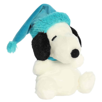 Aurora Palm Pals 5-inch Peanuts Bundled Up Snoopy plush toy sitting forward with classic black-and-white fur and a bright teal winter hat.