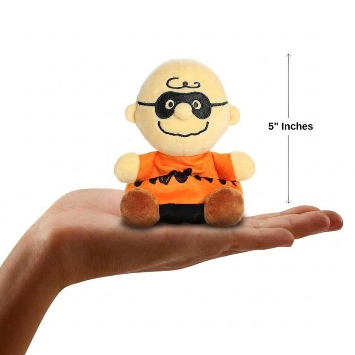 The miniature Masked Charlie Brown plush sitting balanced in an open human hand under a 5-inch height graphic indicator.