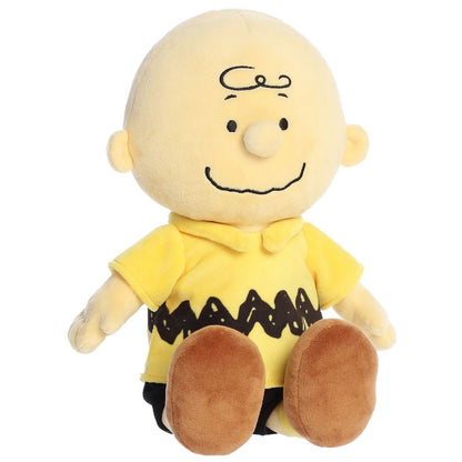 Straight-on front view of the 13-inch Aurora Peanuts Charlie Brown stuffed animal sitting down.