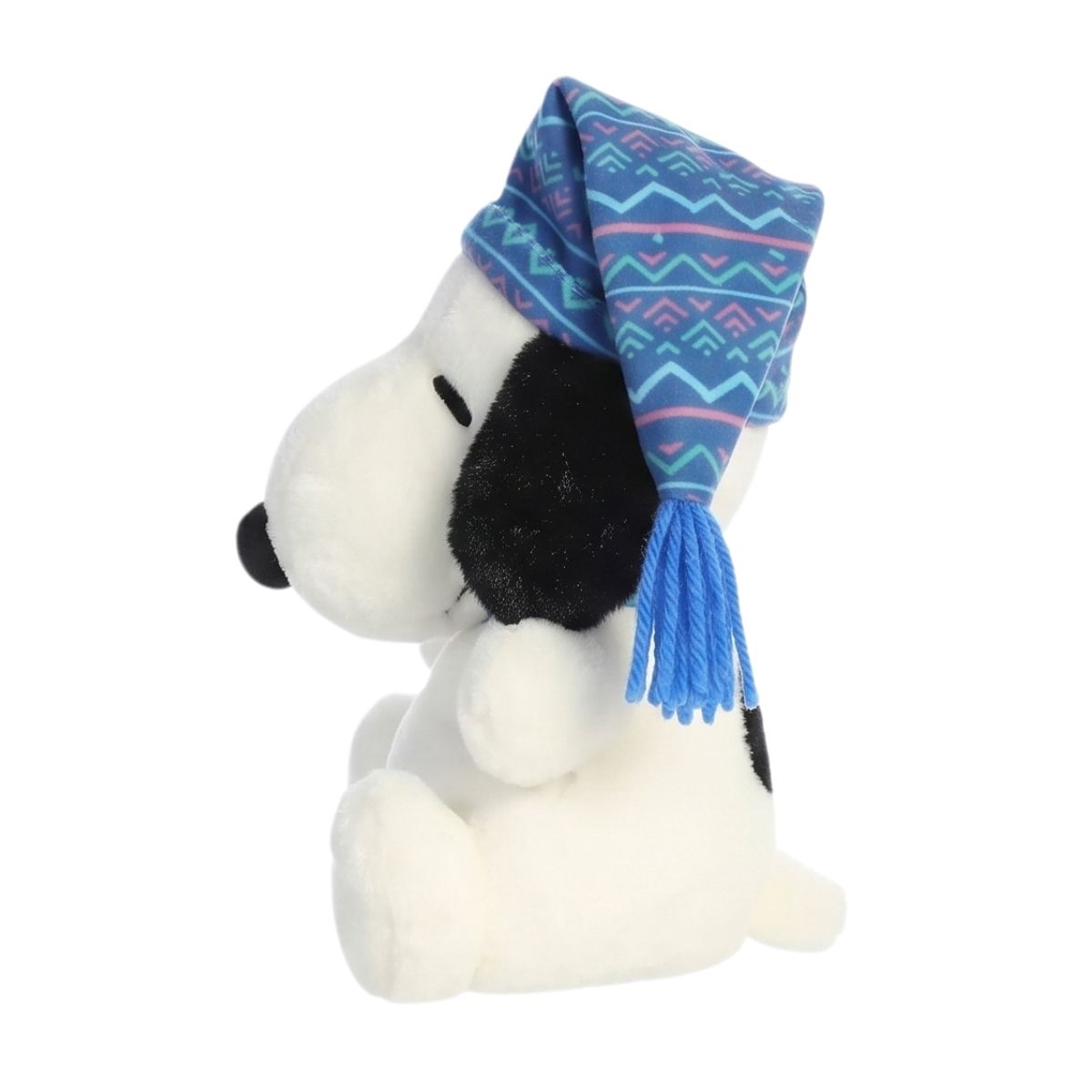 Side profile view of the palm-sized Snoopy plush showing his seated posture, white tail, and the blue tassel hanging from his hat.