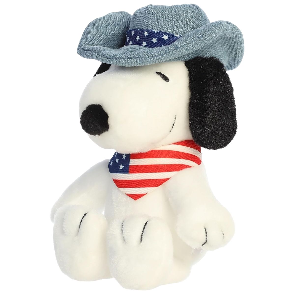 Aurora 8-inch Peanuts Americana Snoopy plush toy sitting forward wearing a denim-look hat with stars and a red, white, and blue striped bandana.