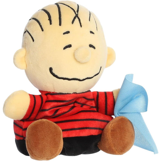 Aurora 5-inch Palm Pals Peanuts Linus plush toy sitting at an angle showing his red and black striped shirt, brown shoes, stitched hair, and blue security blanket.