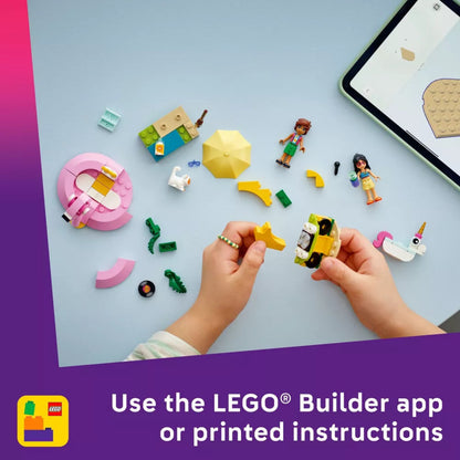 Children playing with LEGO bricks on a light blue surface with a tablet displaying the LEGO Builder app.