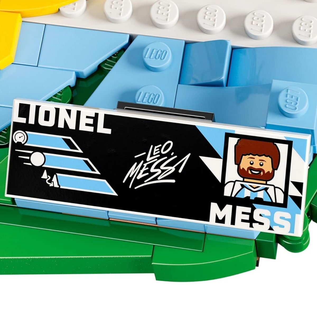 Close-up shot of the printed LEGO® player stat plaque displaying Lionel Messi's name, stats, portrait, and signature.