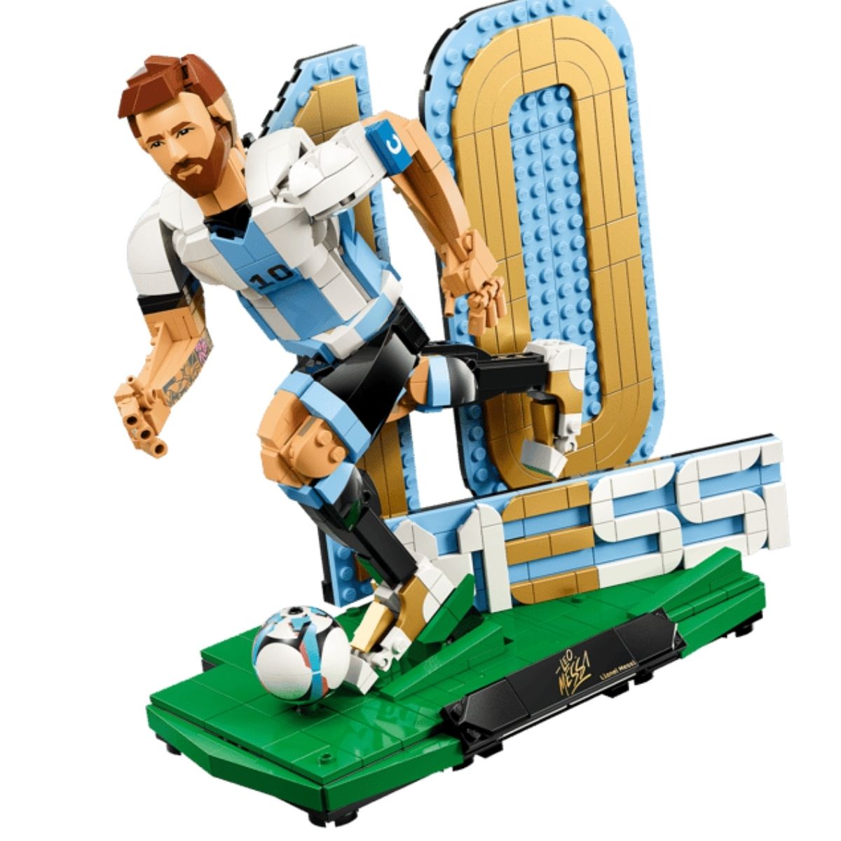 The assembled LEGO® Lionel Messi brick figure posed mid-dribble with a soccer ball on a green pitch base.