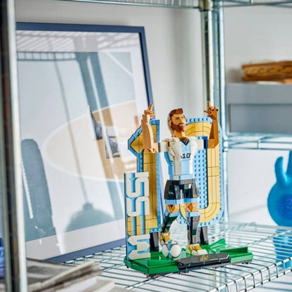 The completed LEGO® Lionel Messi soccer legend display piece sitting elegantly inside a glass showcase cabinet.