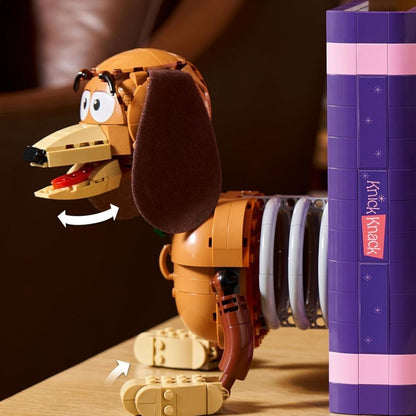 Close-up shot showing a hand turning the back panel of the purple book to actuate the hidden movie scene.